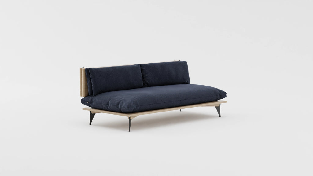 Space saving furniture - Transformable sofa and daybed. Sofa for small space. Transformable sofa in deep dark blue. Modern scandinavian sofa for small space. View at an angle.